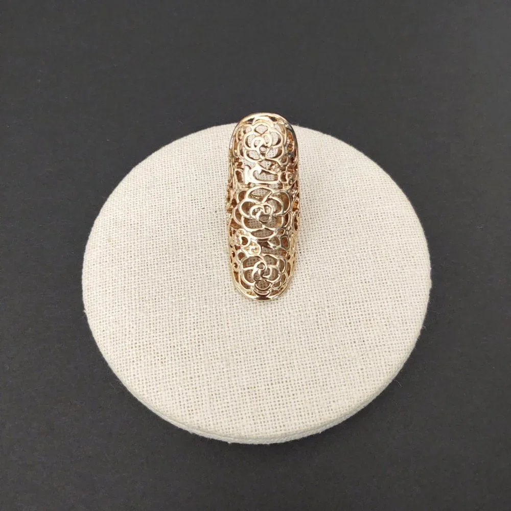 Long, open scroll design gold ring